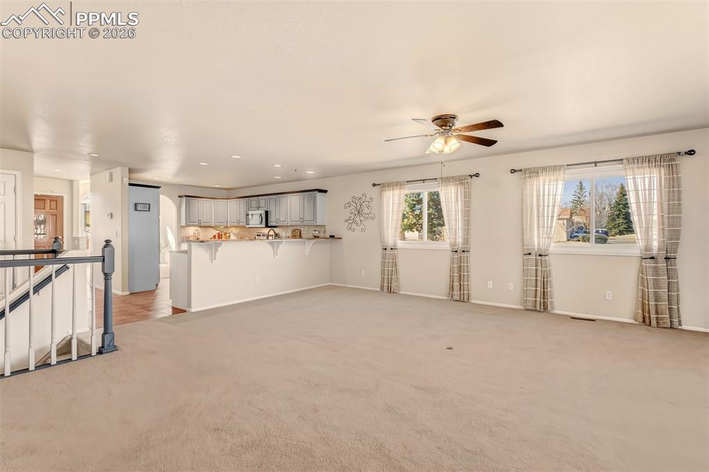 Image 11 of 30: Living room offering a clear view of the kitchen.