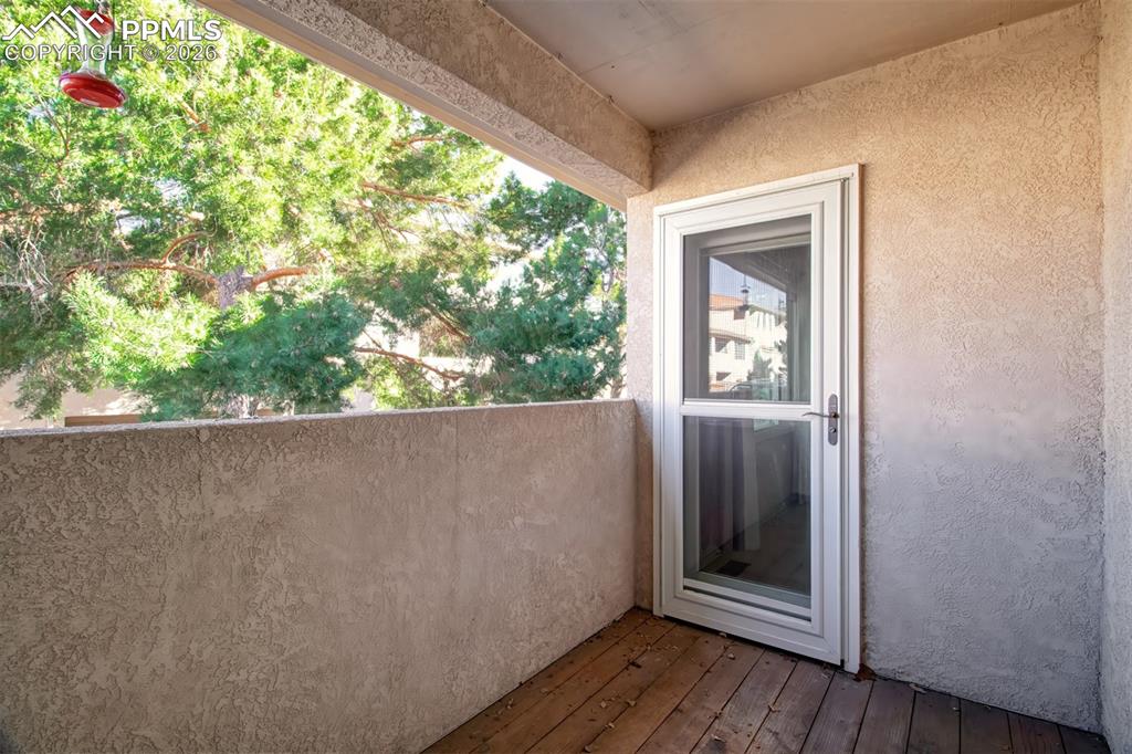 Image 15 of 30: Rear covered patio with access from the master bedroom and the living room.