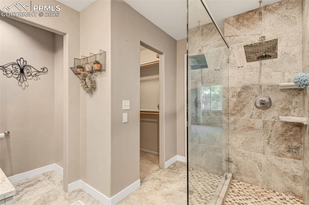 Image 17 of 30: Master shower featuring a single glass side, open entry, tile surround and