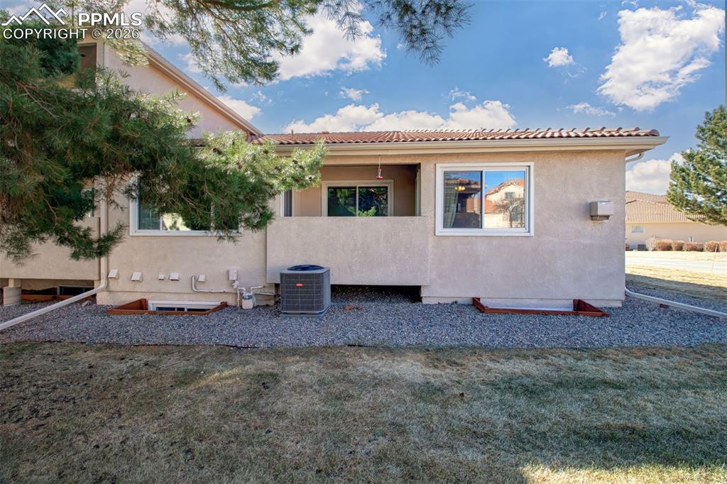 Image 29 of 30: Covered patio at the rear of the home, ideal for morning coffee. 