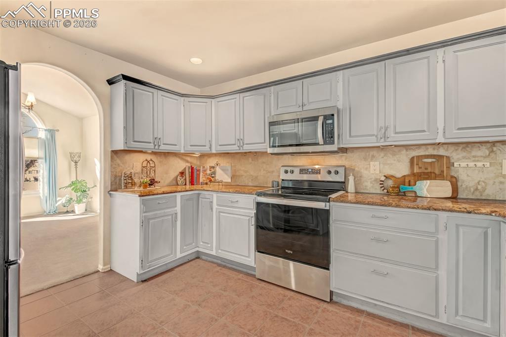Image 5 of 30: View of the kitchen leading into the formal dining room. 