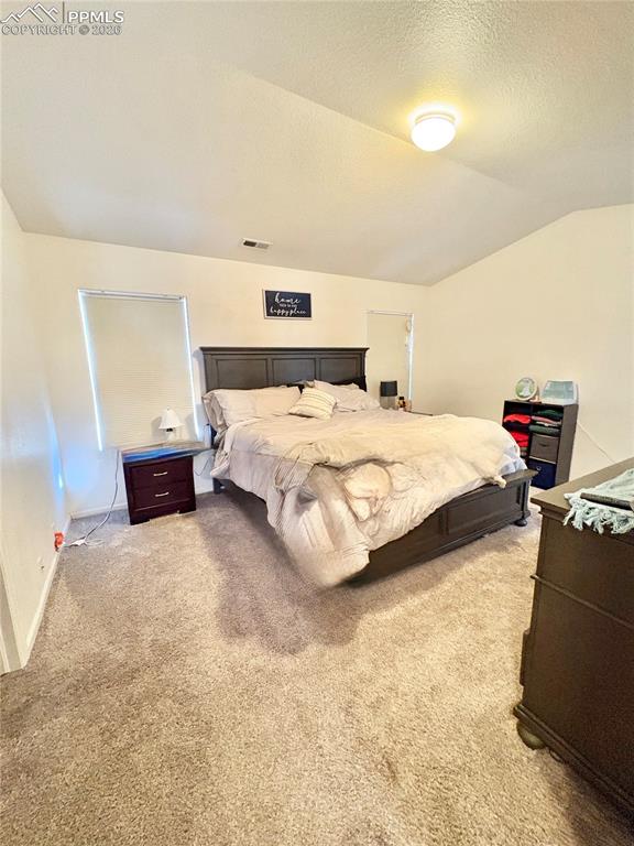 Image 14 of 21: Bedroom featuring light carpet