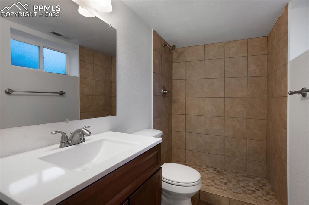 Image 35 of 43: Full bathroom featuring vanity and a shower stall
