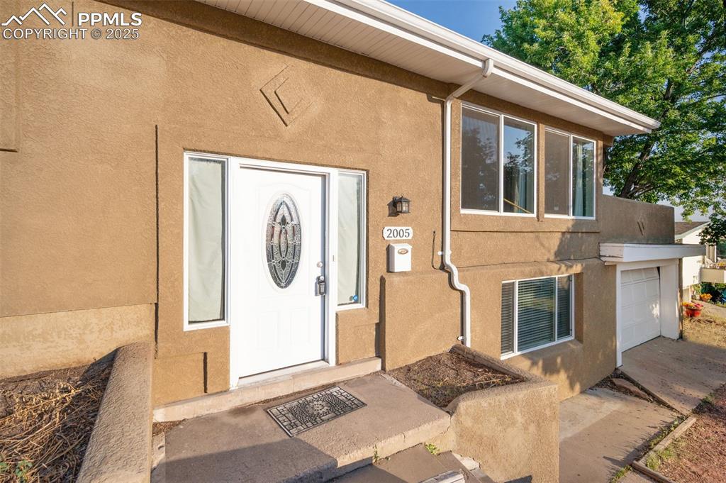 Image 4 of 43: Doorway to property with stucco siding