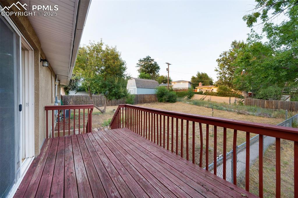 Image 40 of 43: Wooden deck featuring a fenced backyard