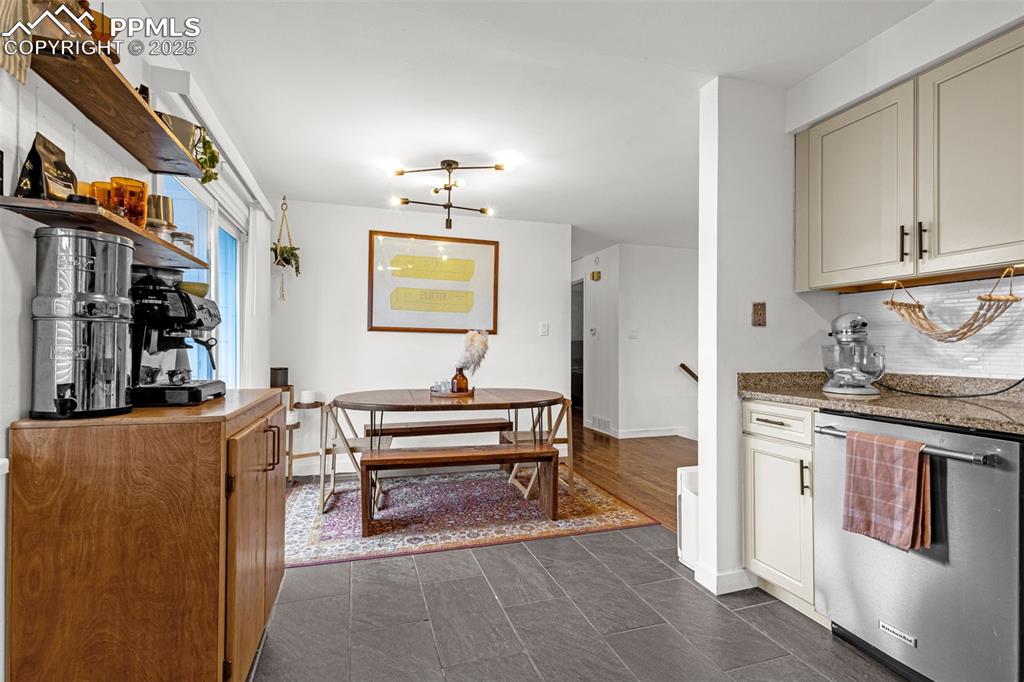 Image 10 of 32: Kitchen with stainless steel dishwasher and tasteful backsplash