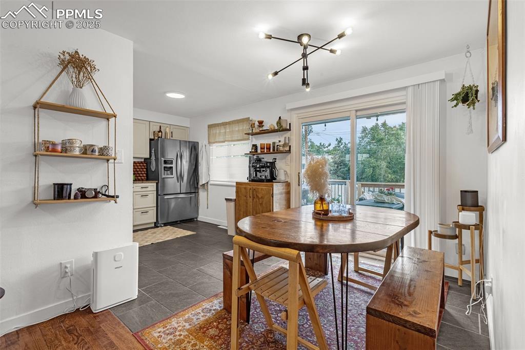 Image 11 of 32: Dining area with baseboards and a chandelier