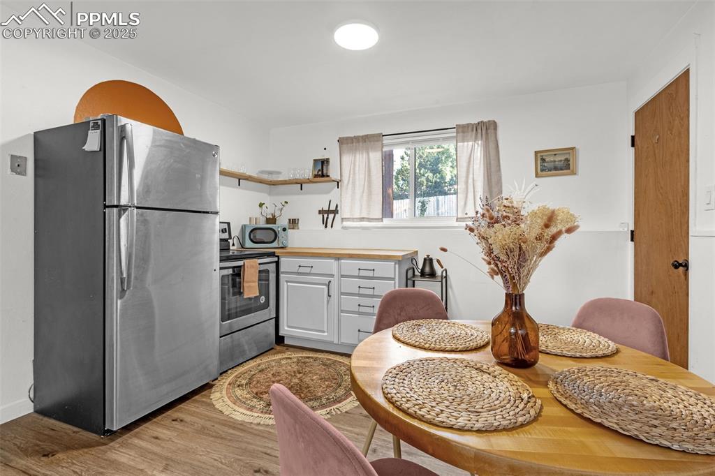 Image 12 of 32: Kitchen featuring appliances with stainless steel finishes, open shelves, l