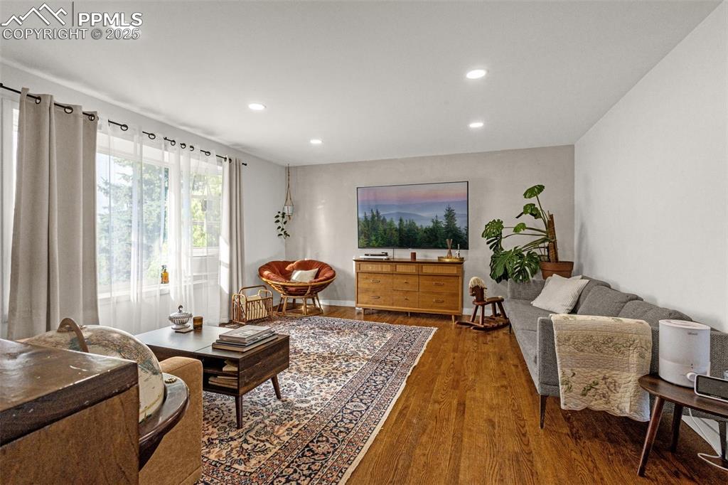 Image 13 of 32: Living area featuring recessed lighting and wood finished floors