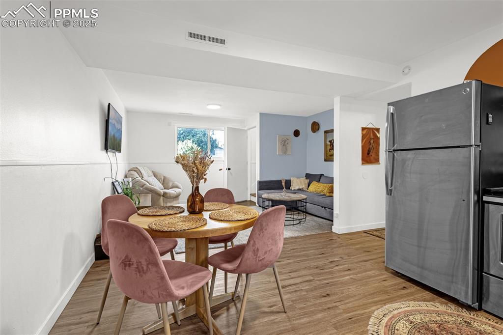 Image 14 of 32: Dining space with light wood-style floors