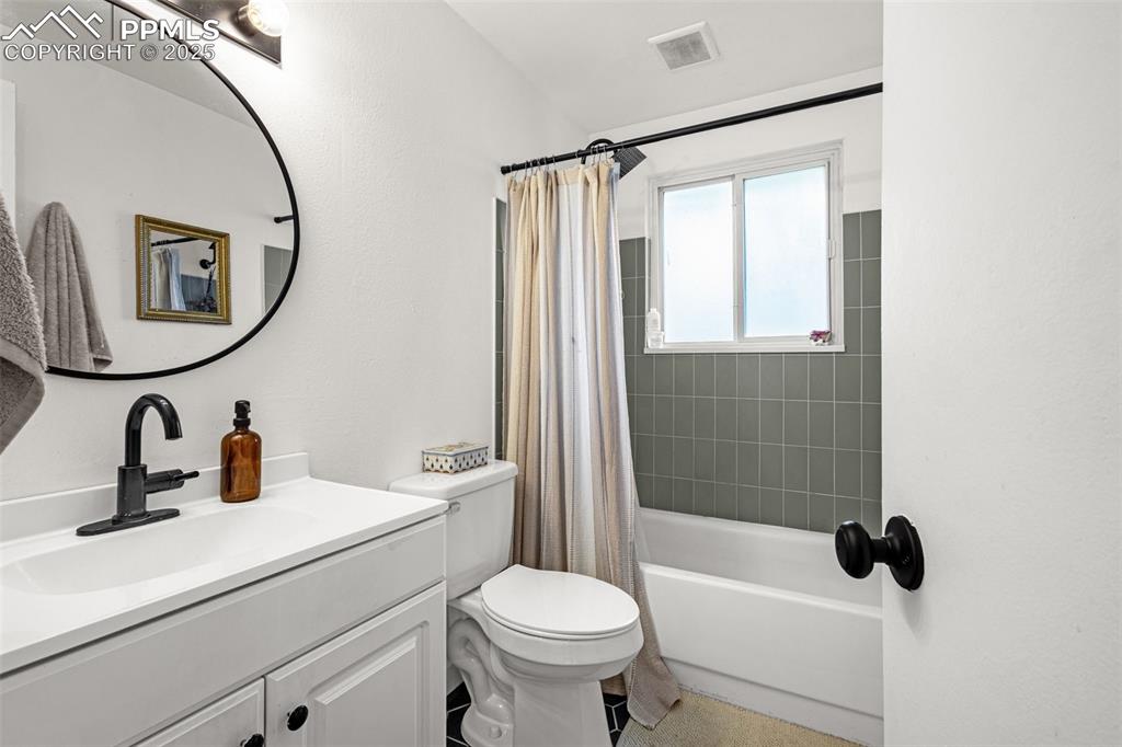 Image 15 of 32: Full bath with vanity and shower / bath combination with curtain