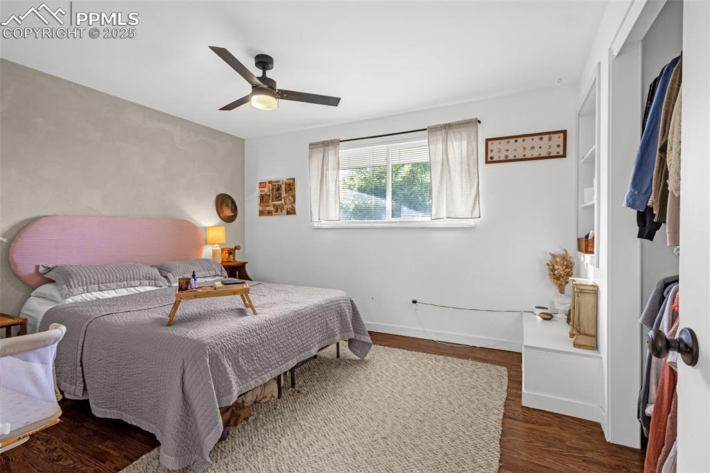 Image 16 of 32: Bedroom featuring wood finished floors and a ceiling fan