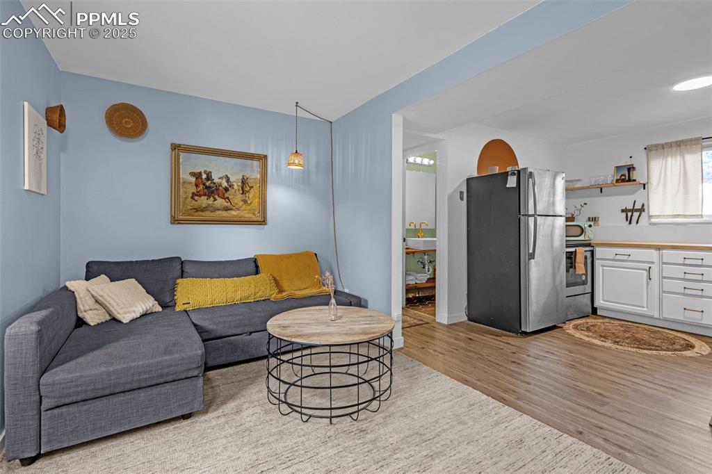 Image 18 of 32: Living room with light wood-style floors