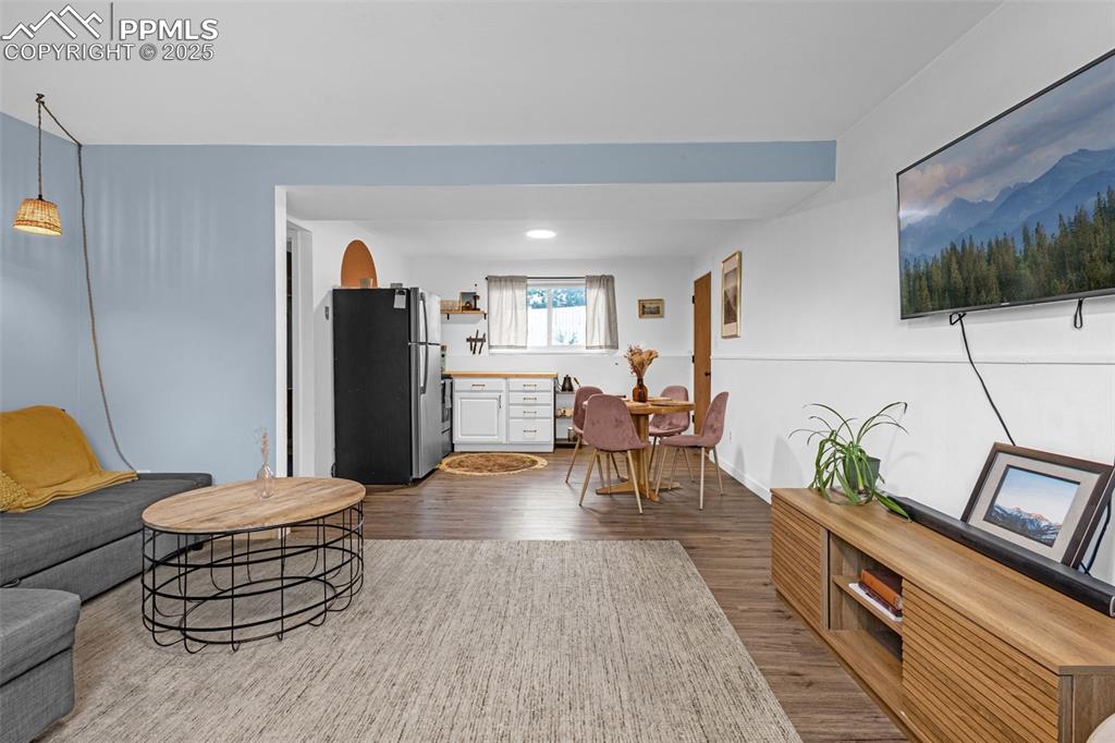 Image 20 of 32: Living area with dark wood finished floors