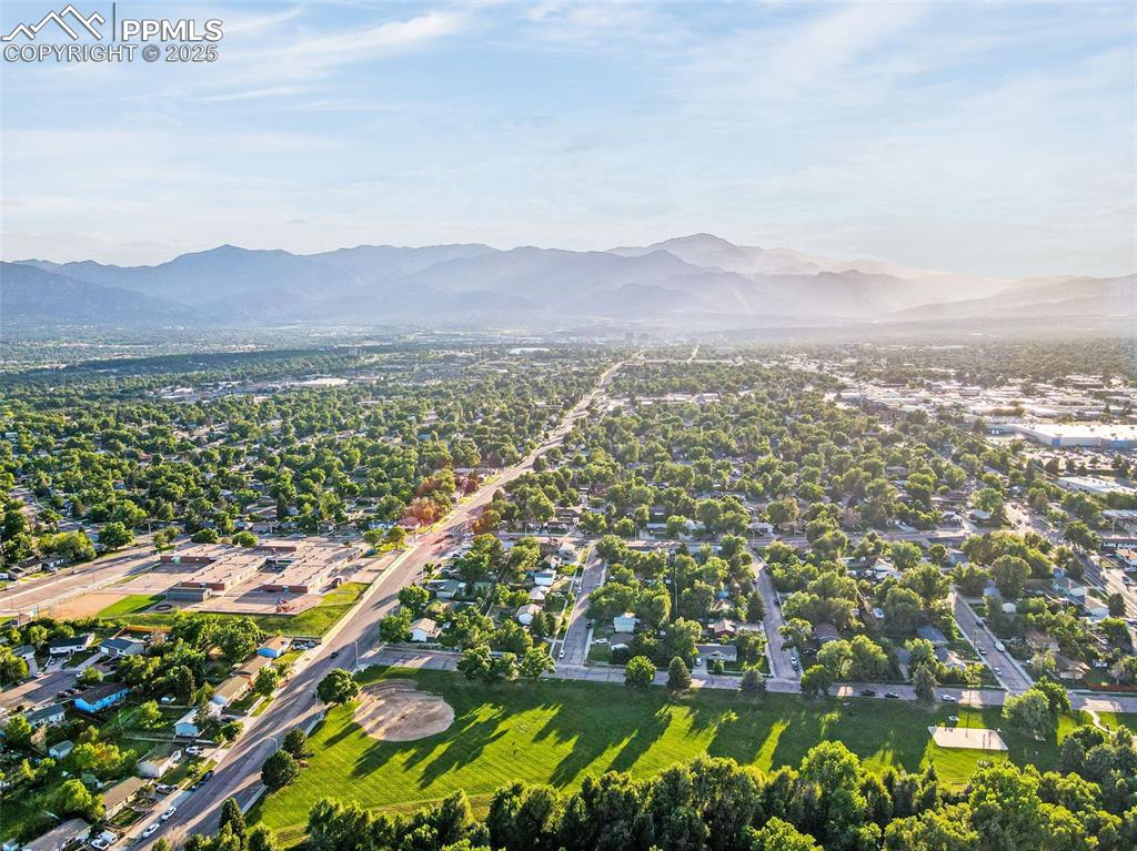 Image 28 of 32: View of property location with a mountainous background and nearby suburban