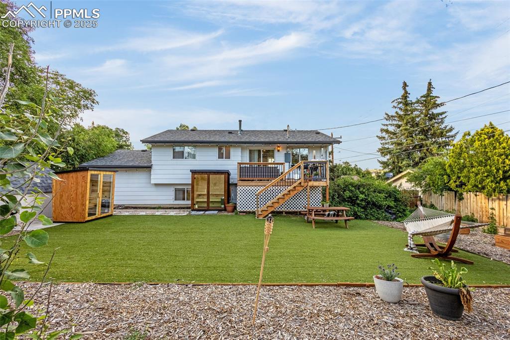Image 4 of 32: Back of house with a deck, stairs, and french doors