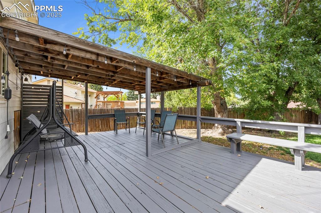 Image 12 of 50: Deck with a fenced backyard