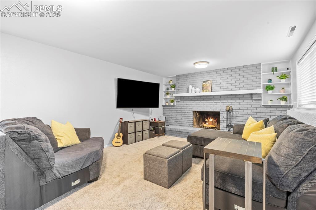 Image 26 of 50: Family room with wood burning fireplace