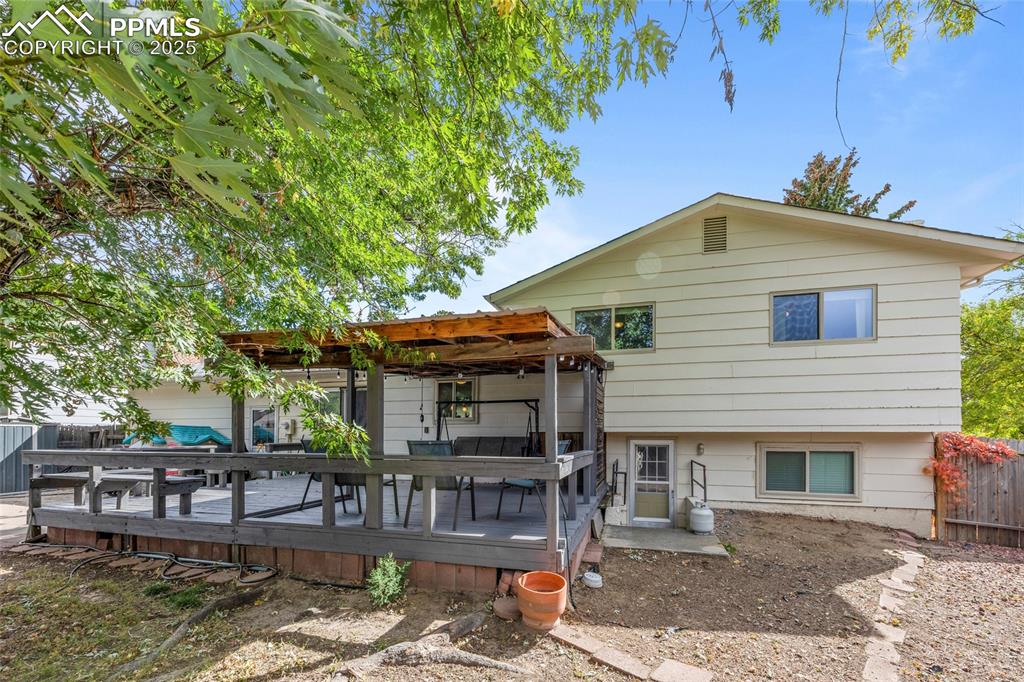 Image 40 of 50: Rear view of house with a wooden deck