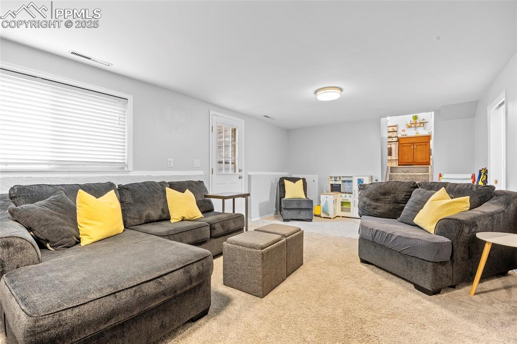 Image 5 of 50: Living area featuring light colored carpet