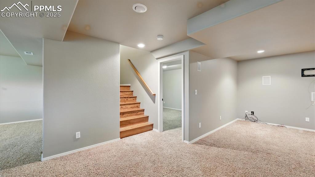 Image 12 of 50: The finished walk-out basement is built for entertaining, featuring a home 