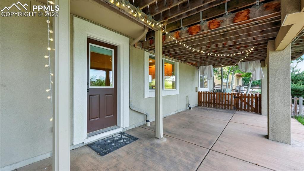 Image 14 of 50: Covered backyard patio located off the Basement Rec Room.