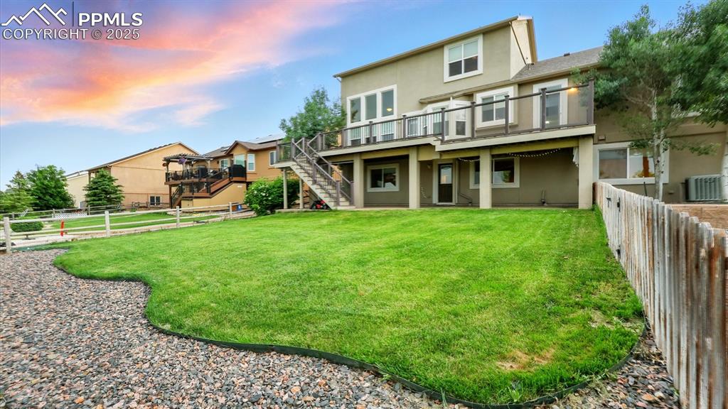 Image 16 of 50: Beautifully fenced backyard with auto sprinklers, composite deck, covered p