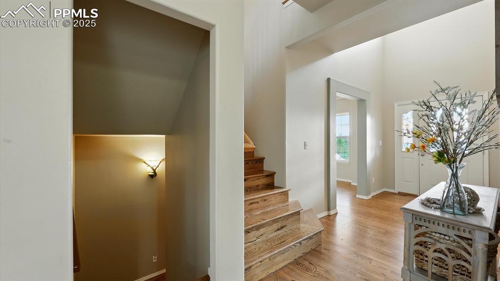 Image 18 of 50: Front Entry into the home office, and stairs to the upper and basement leve