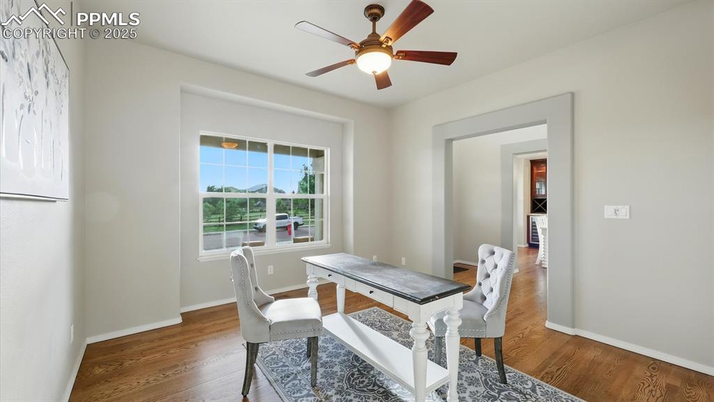 Image 19 of 50: Home Office located off the Front Entry features a lighted ceiling fan and 
