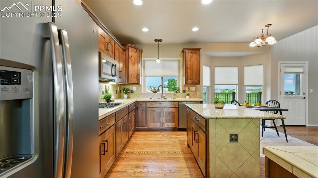 Image 23 of 50: The Gourmet Island Kitchen features a breakfast bar, dining nook with bay w