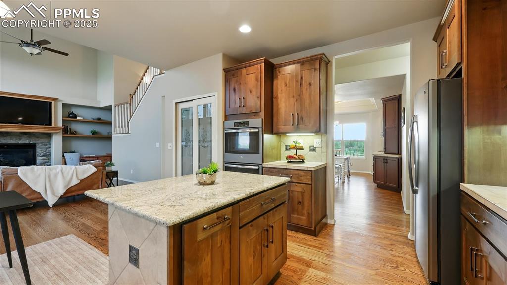 Image 24 of 50: The Kitchen also includes a pantry and stainless steel appliances.