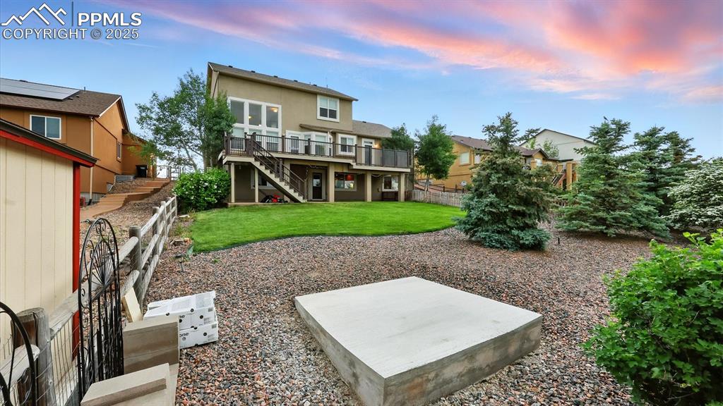 Image 48 of 50: Gorgeous backyard with grass area and fenced, xeriscaped area with raised p