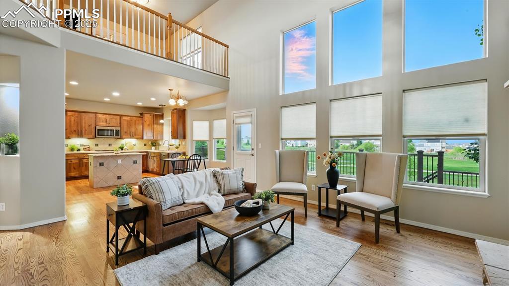 Image 5 of 50: The soaring ceilings & gas-log fireplace with custom cabinetry & built-in d