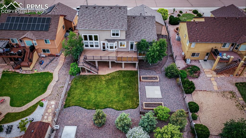 Image 50 of 50: Aerial rear view of home and meticulously landscaped backyard with a compos