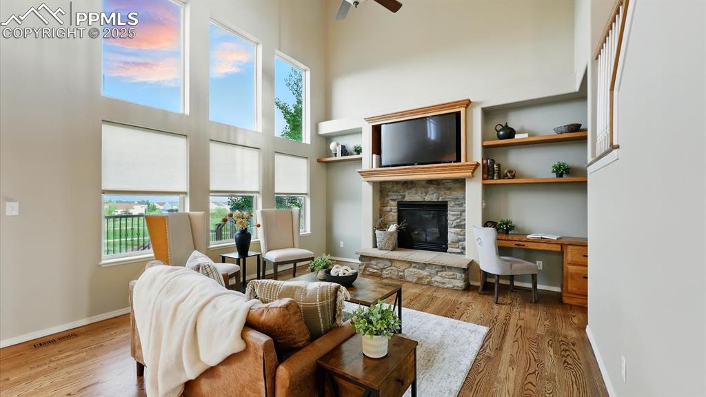 Image 8 of 50: Living Room with soaring ceilings, wall of windows, built-in shelves, and f