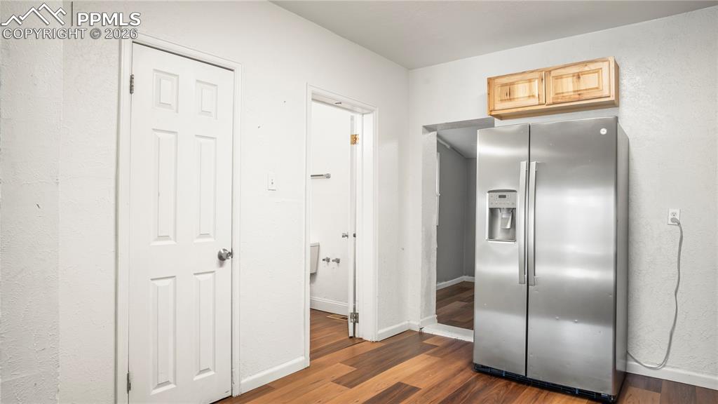 Image 11 of 20: Kitchen featuring stainless steel fridge with ice dispenser, dark wood-styl