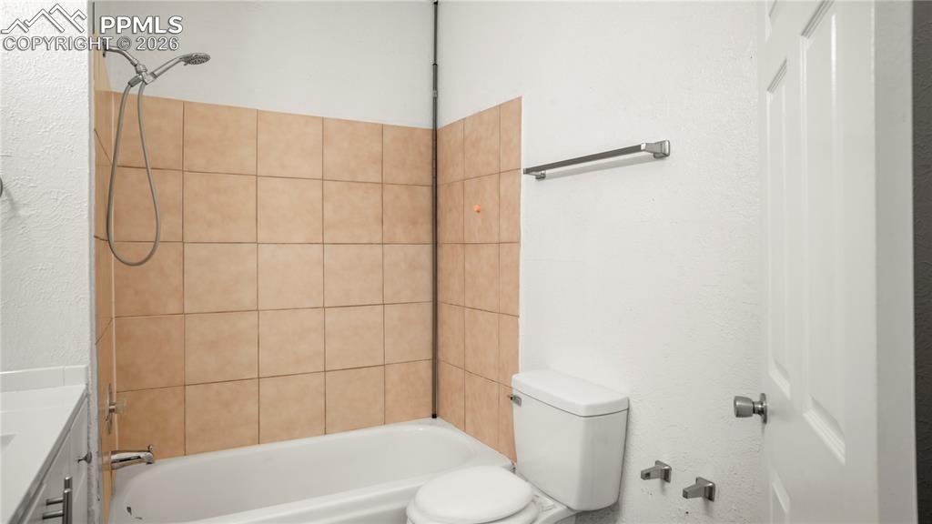 Image 13 of 20: Full bathroom with vanity,  shower combination, and a textured wall