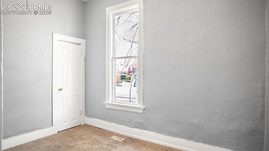 Image 6 of 20: Spare room featuring a textured wall and carpet flooring
