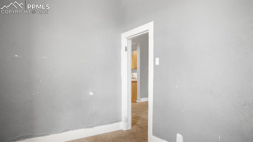 Image 7 of 20: Unfurnished room with carpet and a textured wall