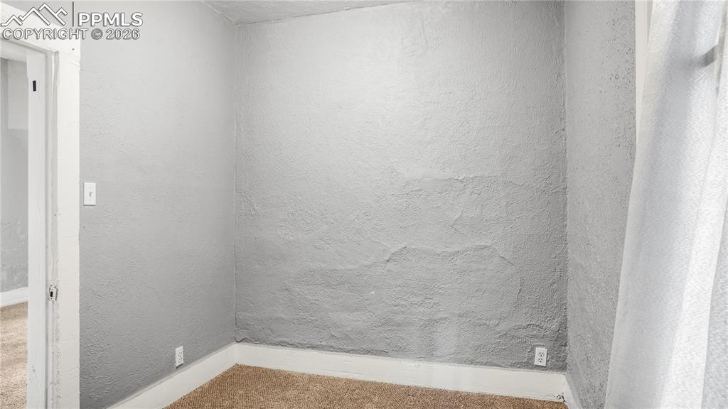 Image 8 of 20: Carpeted empty room featuring baseboards and a textured wall