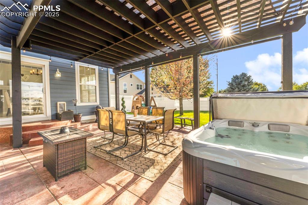 Image 27 of 47: Covered patio with Hot tub