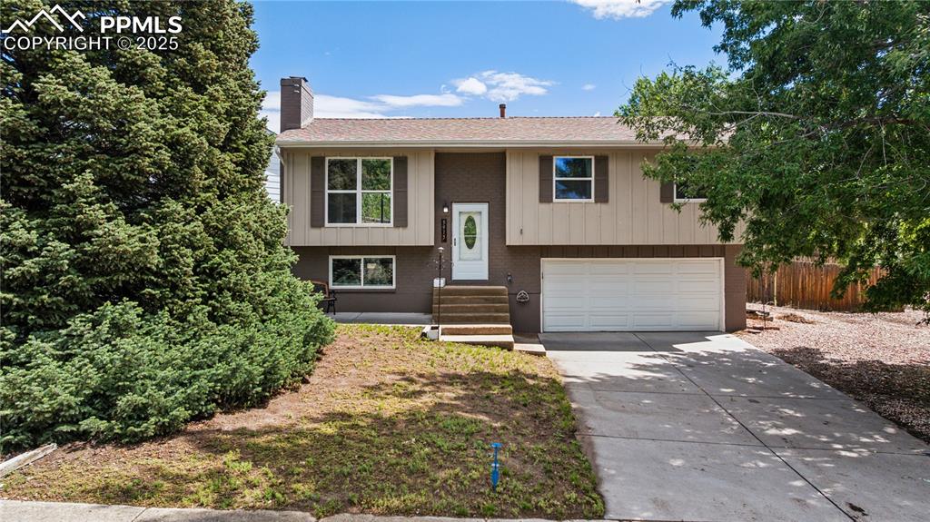 Image 1 of 35: Bi-Level featuring  concrete driveway, and two-car garage