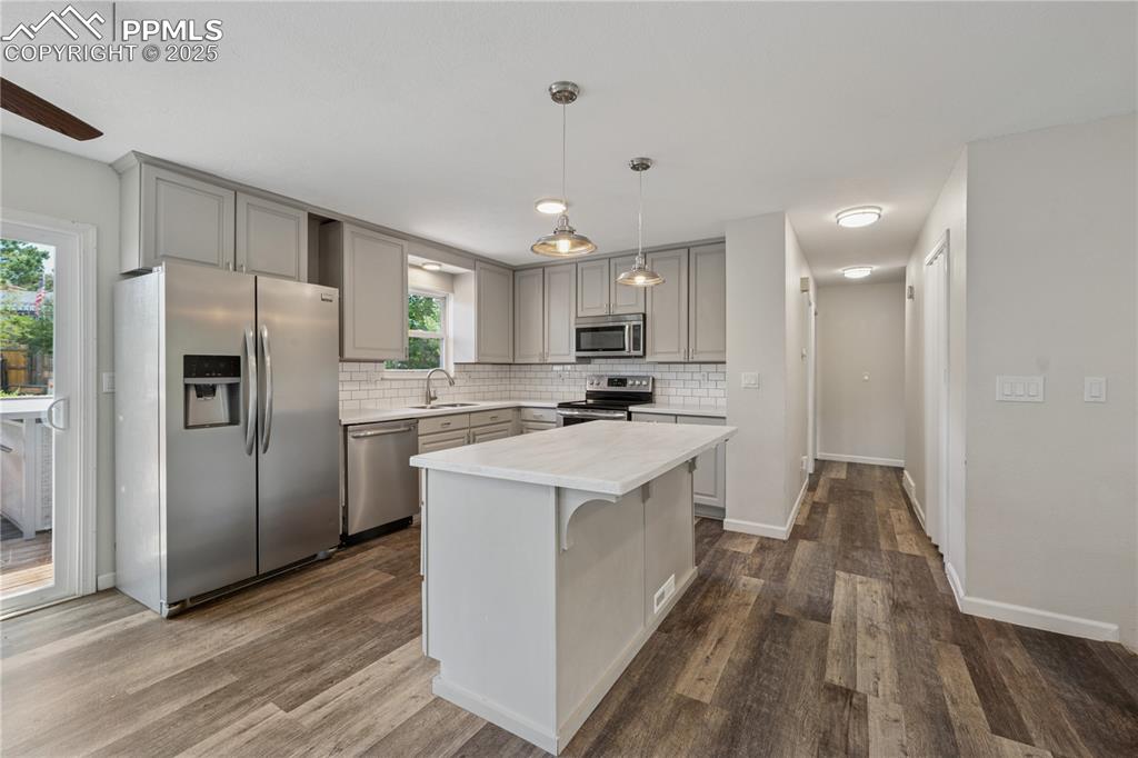 Image 15 of 35: Kitchen featuring appliances with stainless steel finishes, gray cabinets, 