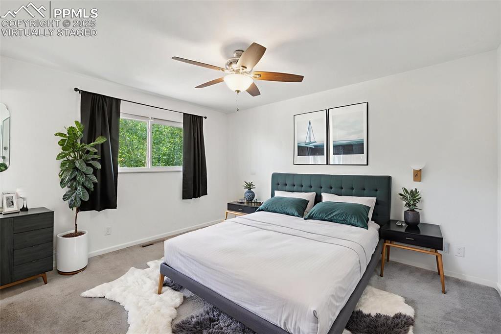 Image 19 of 35: Bedroom featuring carpet flooring and ceiling fan. Virtually Staged.