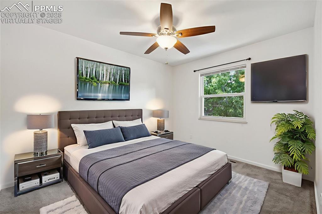 Image 23 of 35: Bedroom featuring carpet flooring and ceiling fan. Virtually Staged. 