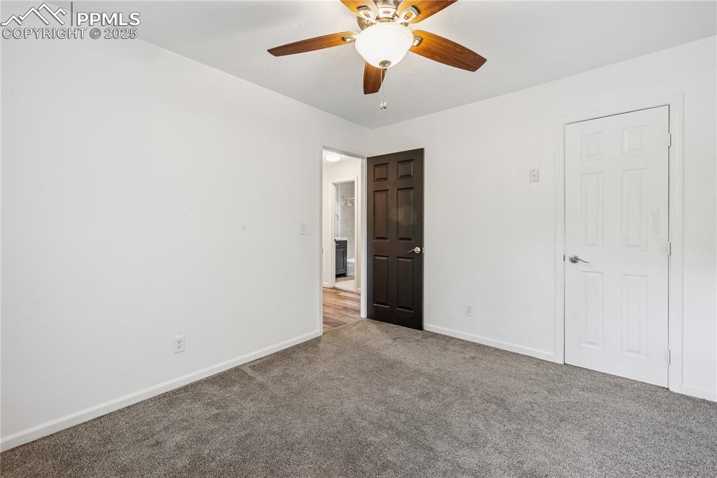 Image 25 of 35: Unfurnished bedroom featuring carpet and a ceiling fan