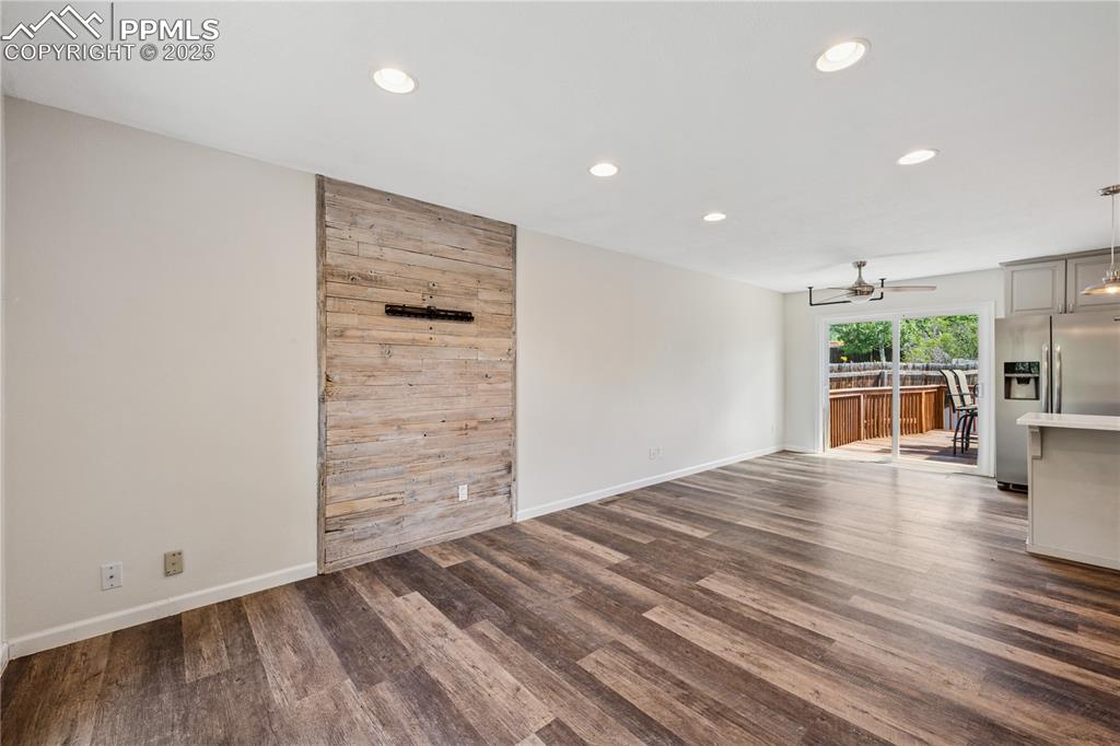 Image 9 of 35: Living room/dining room with recessed lighting, ceiling fan, and dark wood-