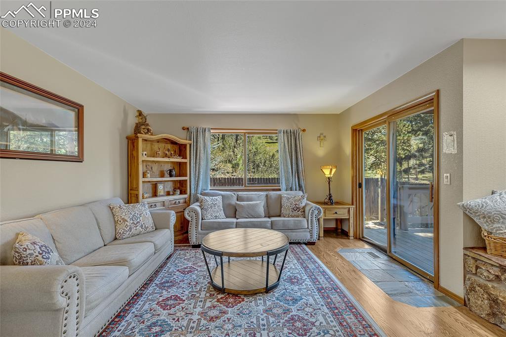 Image 11 of 39: Family Room, Hardwood Floors, Rug,