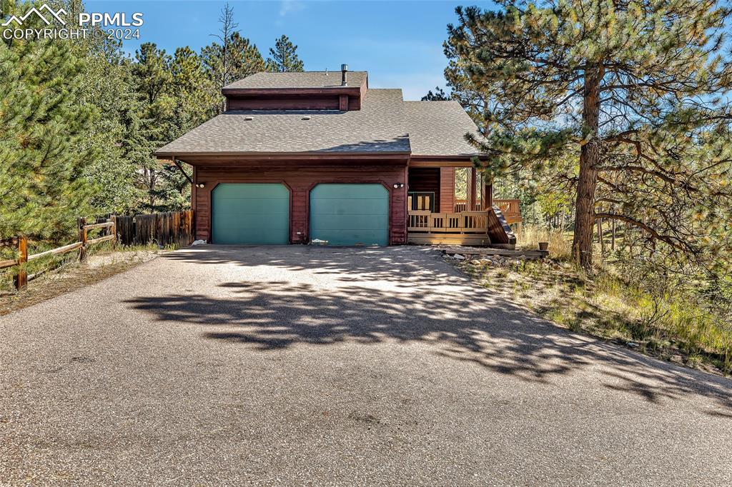 Image 2 of 39: Front View, Garage, Patio, Deck, Nature,