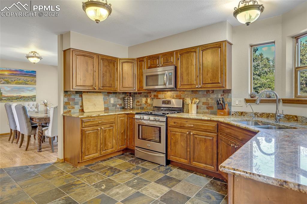 Image 6 of 39: Gorgeous Kitchen, Granite Countertops, Wooden Cabinets, Tile Floor, Attache